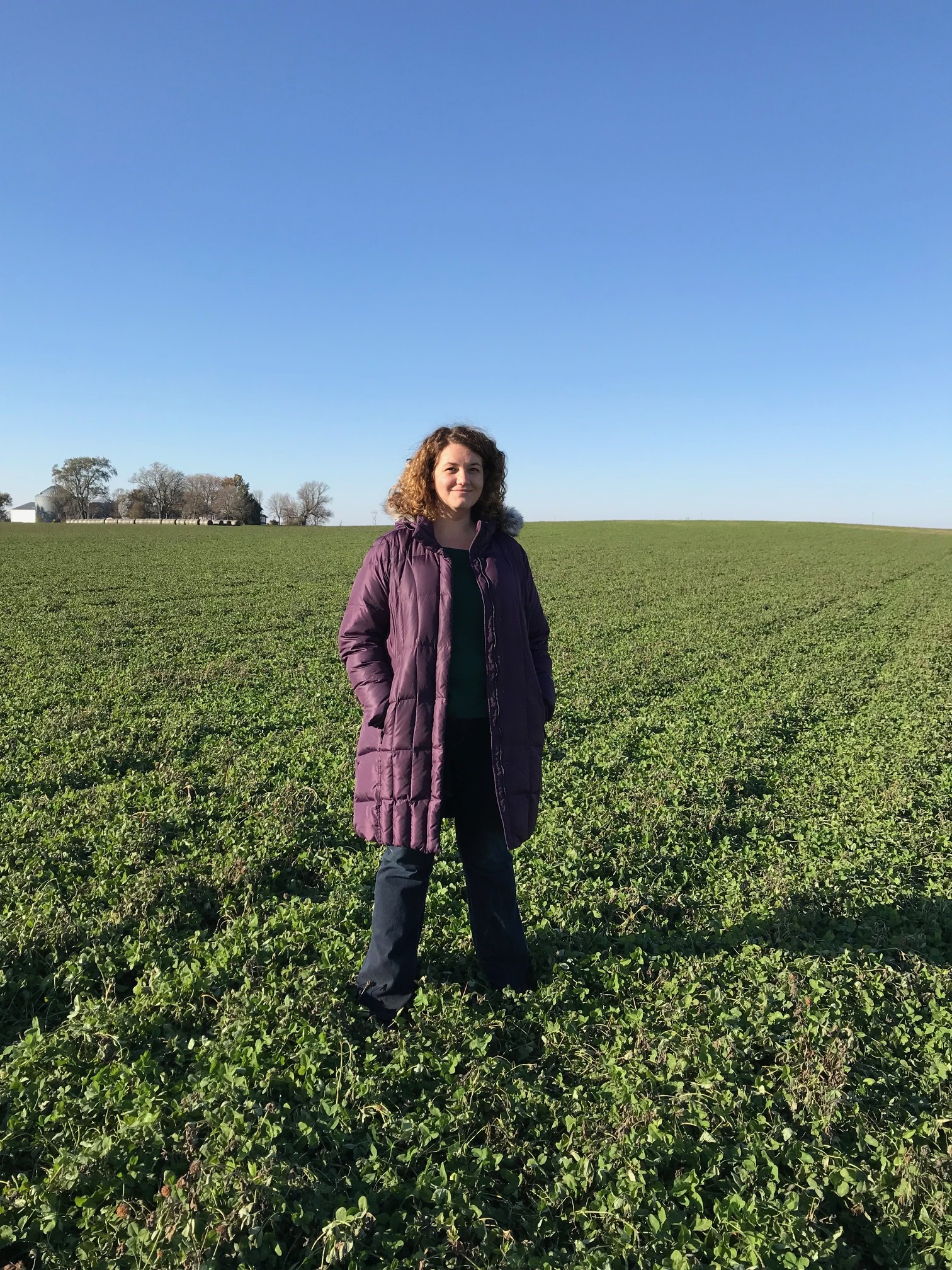 Lara Bryant standing in a cover crop field